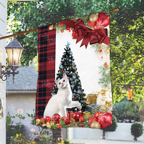 Japanese Bobtail Cat Flag Sitting In Front Of The Christmas Tree