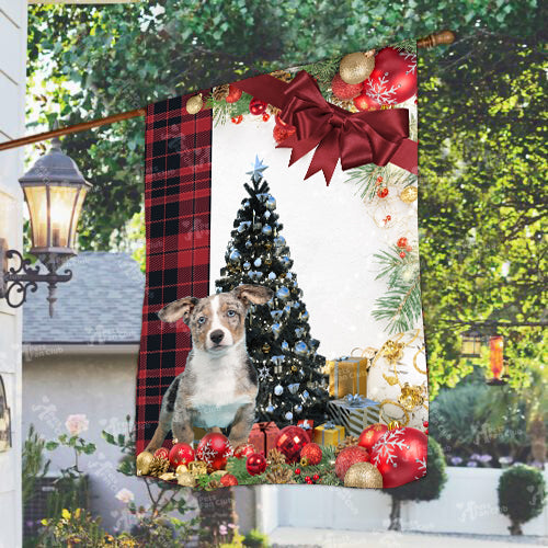 Merle Welsh Corgi Puppy Flag Sitting In Front Of The Christmas Tree