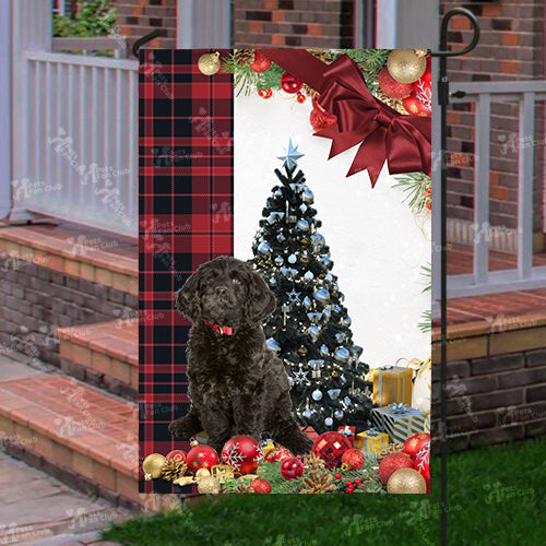 Black Labradoodle Flag Sitting In Front Of The Christmas Tree