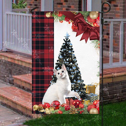 Japanese Bobtail Cat Flag Sitting In Front Of The Christmas Tree